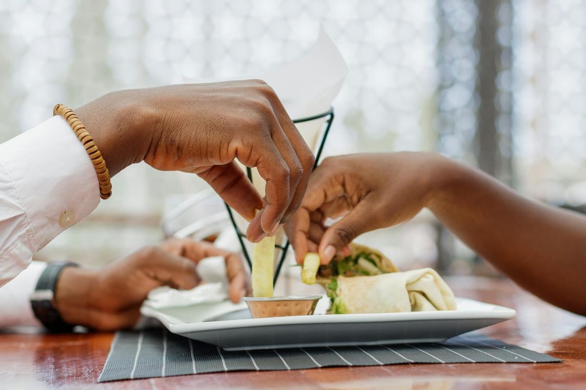 A couple sharing food at a restaurant. Intimate and casual dining scene.