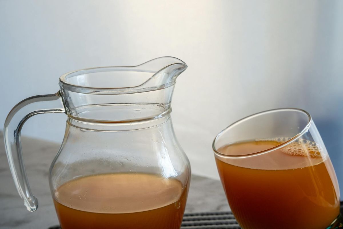 Refreshing orange juice served in a glass and jug.