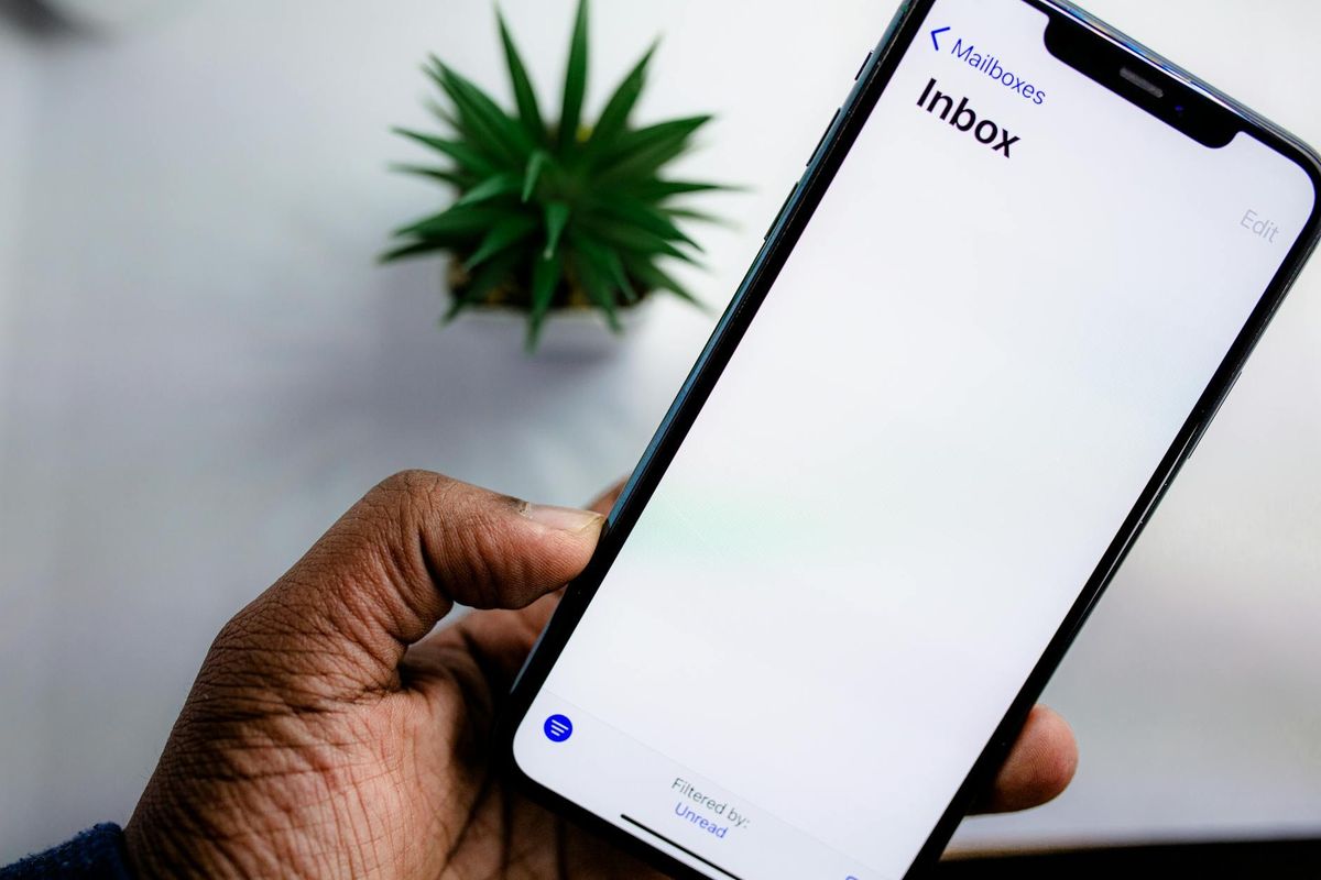 A close-up view of a smartphone screen displaying an email inbox.